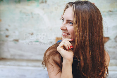 Buy stock photo Cropped shot of a young woman sitting outside while exploring a foreign city