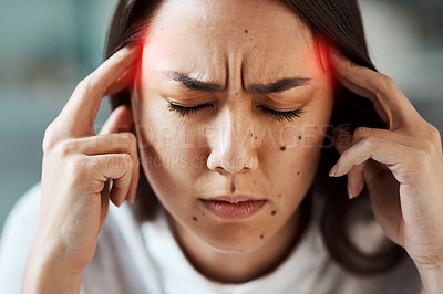 Buy stock photo Shot of a young woman suffering with a headache highlighted in red