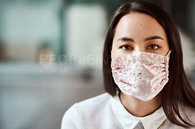Buy stock photo Portrait of a young businesswoman wearing a mask in an office