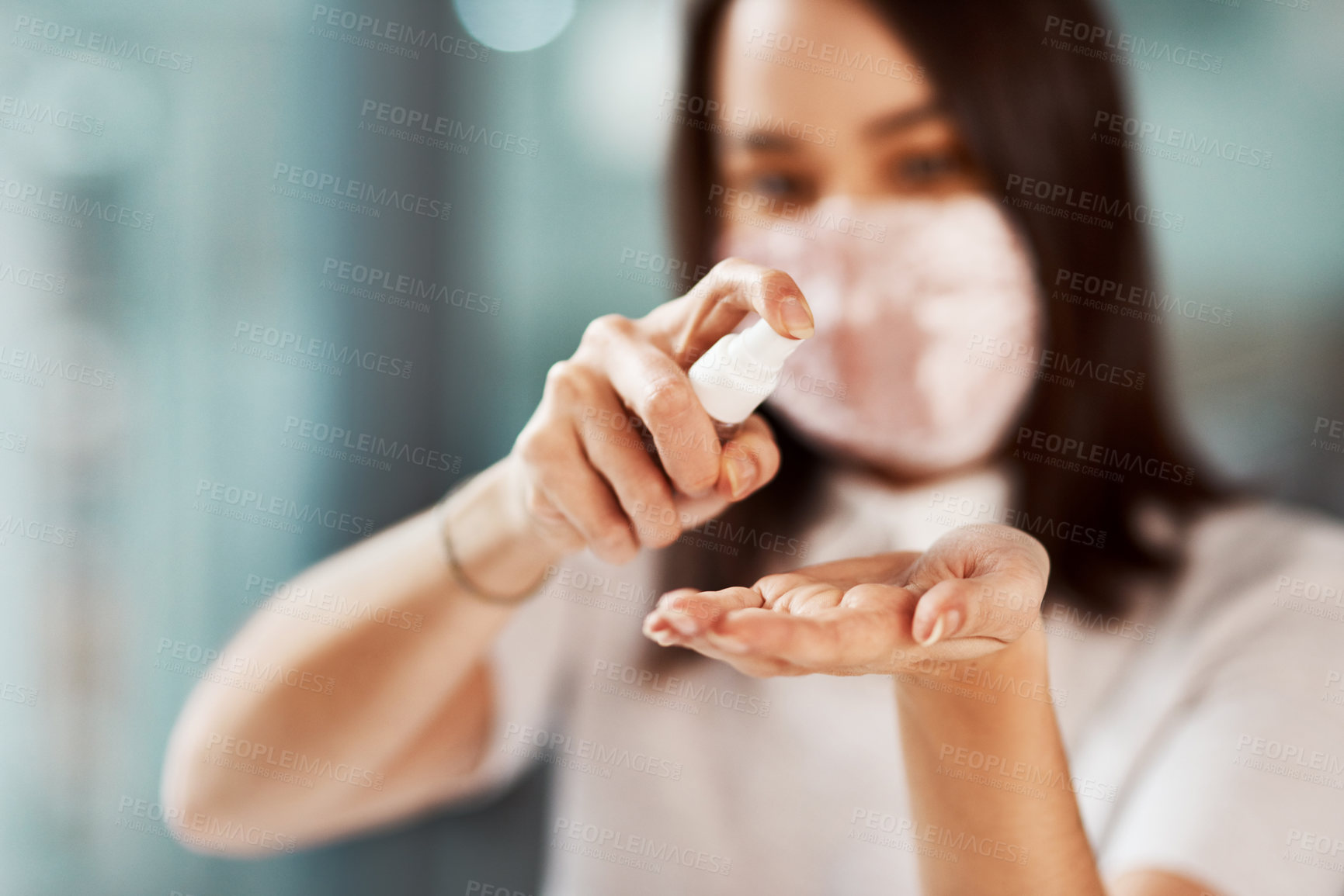 Buy stock photo Closeup shot of a businesswoman using hand sanitiser in an office