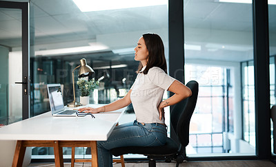 Buy stock photo Back pain, office and business woman with stress, muscle ache and tension in sitting posture. Health, medical emergency and female worker at desk with spine problem, tendinitis and injury on laptop 