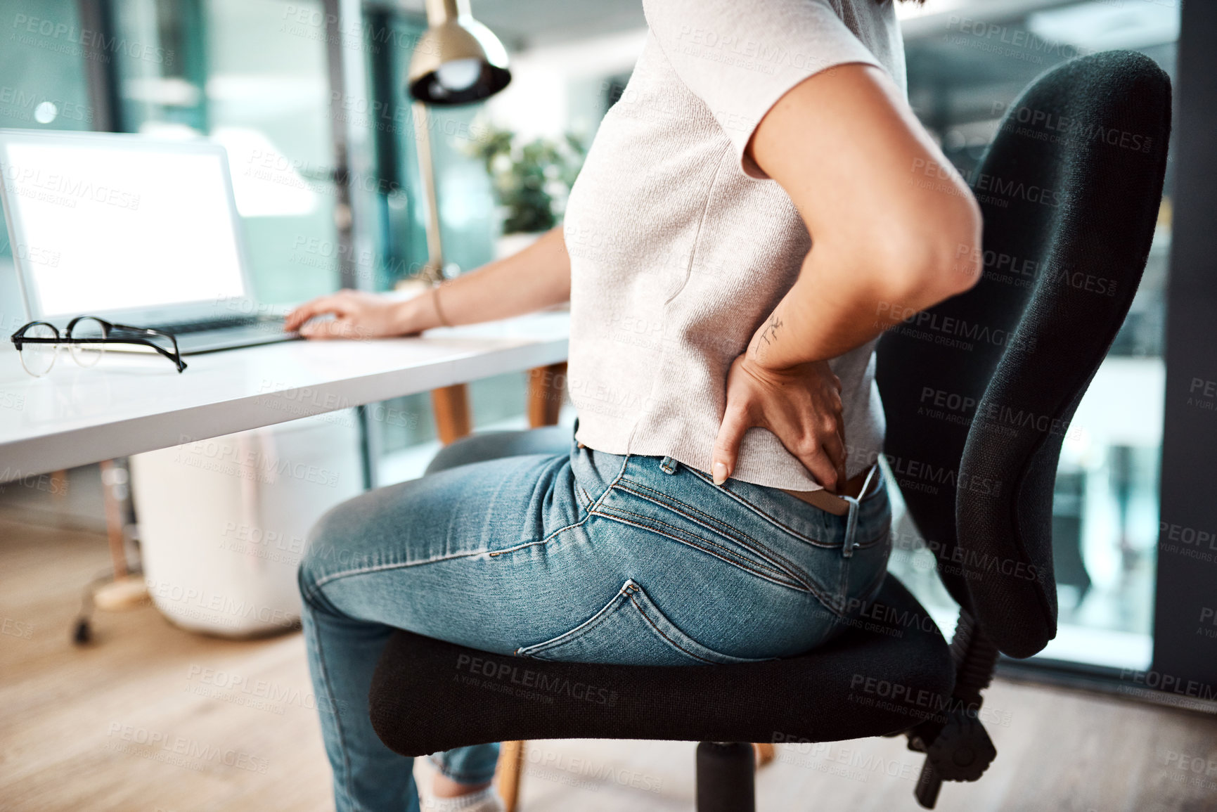 Buy stock photo Back pain, stress and business woman at desk with burnout, muscle ache and tension in sitting posture. Health, medical emergency and female worker with spine problem, accident and injury in office