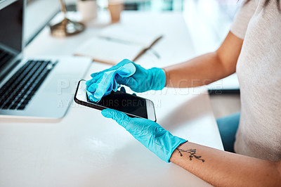 Buy stock photo Closeup shot of an unrecognisable businesswoman cleaning a cellphone in an office