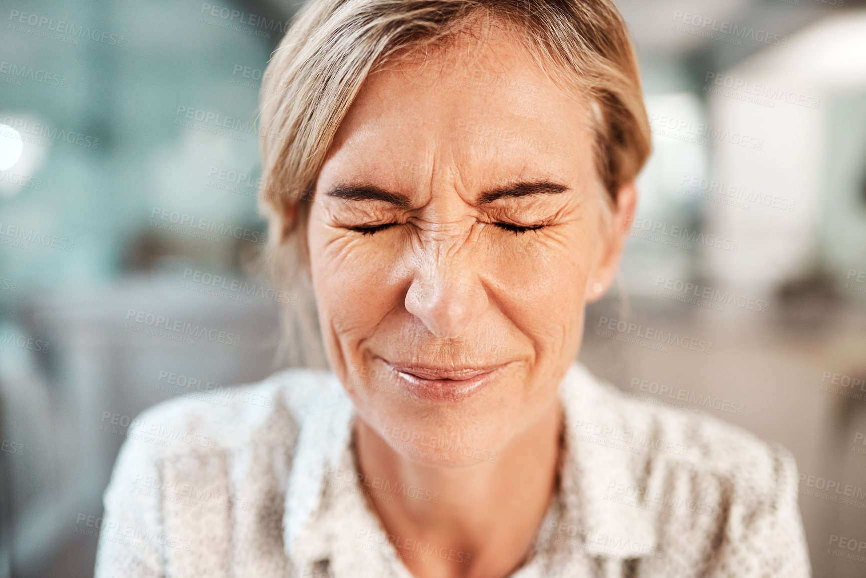 Buy stock photo Shot of a mature woman closing her eyes in pain