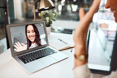 Buy stock photo Shot of a young woman waving while appearing on a laptop screen during a video call