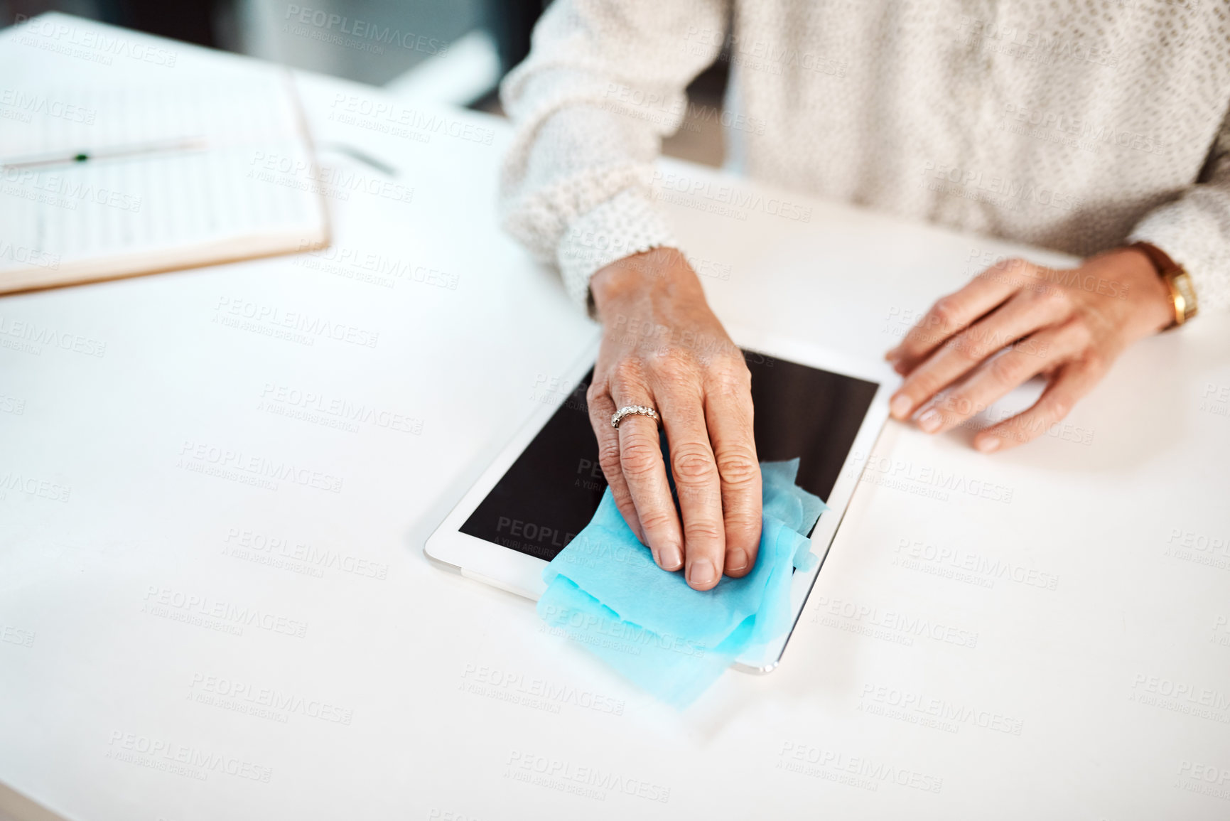 Buy stock photo Closeup shot of an unrecognisable businesswoman cleaning a digital tablet in an office