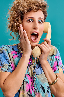 Buy stock photo Studio shot of a young woman holding a telephone while wearing 80s clothing