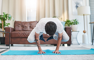 Buy stock photo Balance, power and strength with man in living room of apartment for development or holistic fitness. Exercise, health and yoga with person in pendant pose at apartment for challenge or wellness