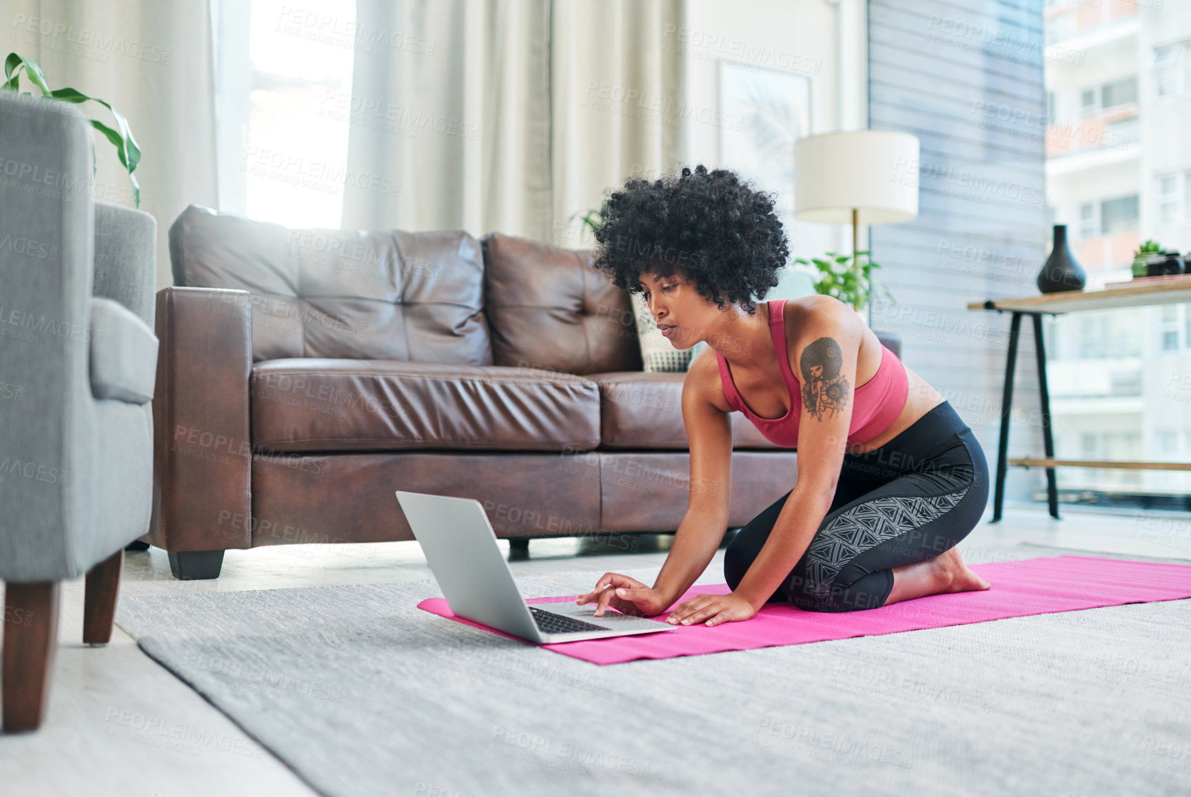 Buy stock photo Yoga, woman and laptop on floor in home for online pilates routine and watching exercise video for tutorial. Wellness influencer, yogi and tech on mat for virtual class and fitness lesson in lounge