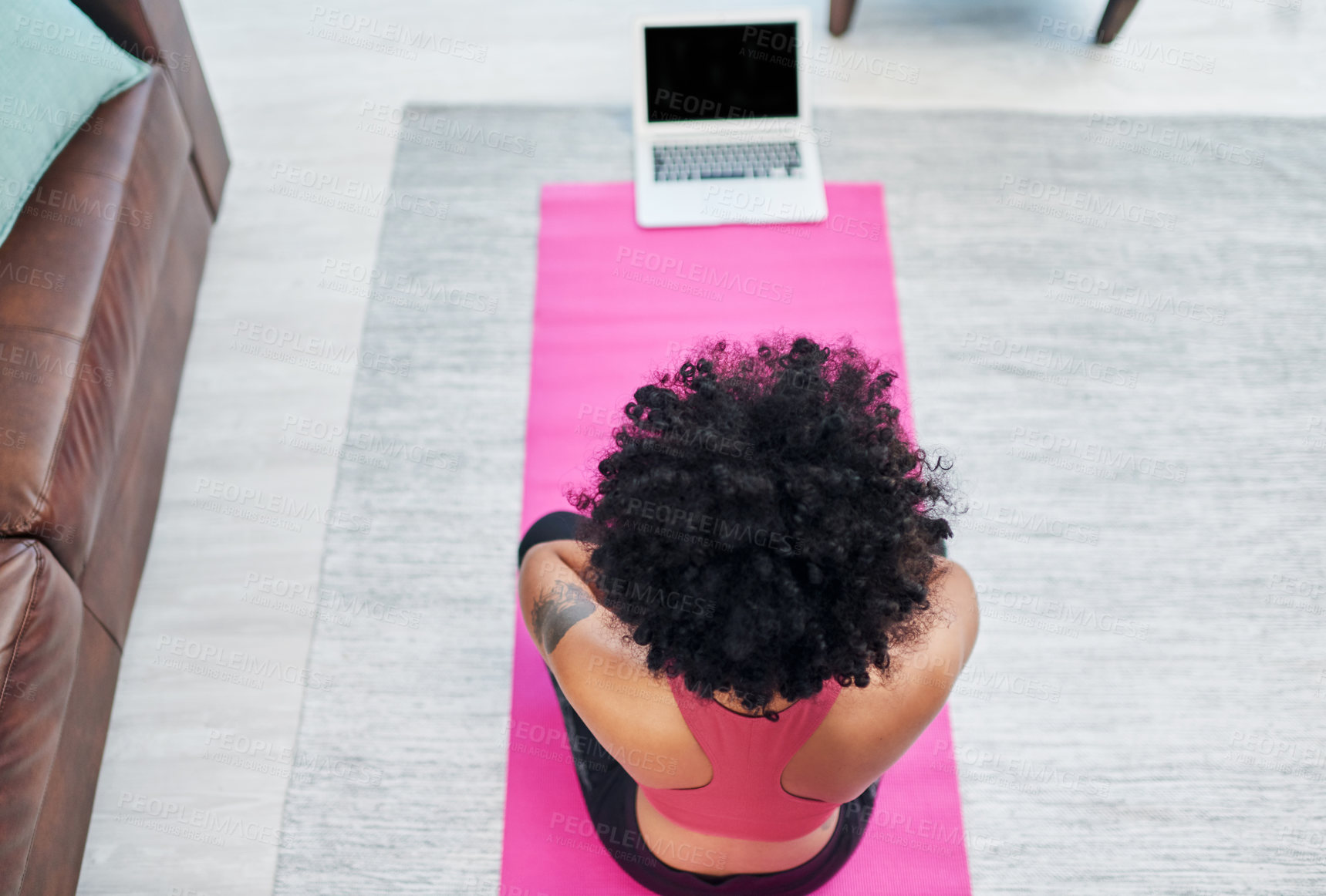 Buy stock photo Shot of a young woman using her laptop while practising yoga at home