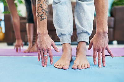 Buy stock photo Cropped shot of an unrecognizable couple practising yoga at home