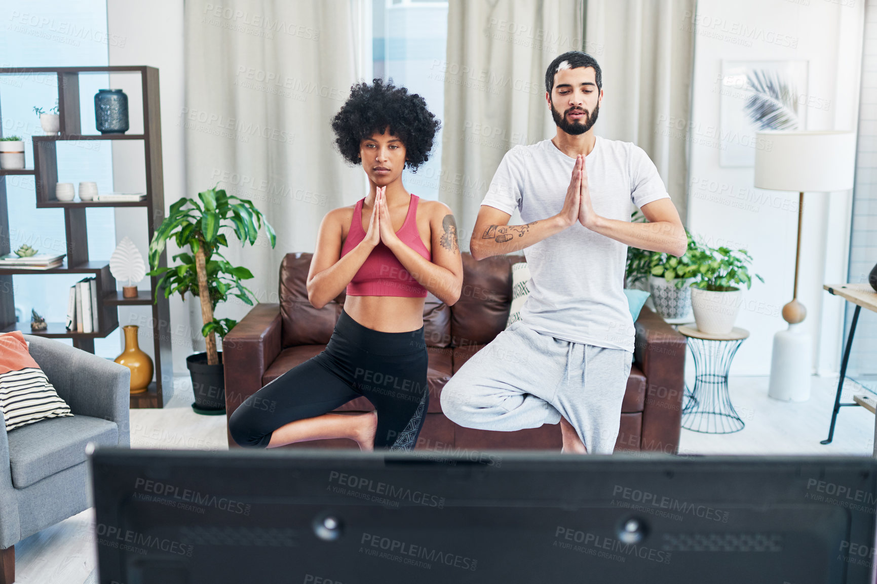 Buy stock photo Meditation, television and yoga with couple in living room of home for balance or holistic exercise. Fitness, streaming or watching tv with man and woman in apartment for pilates or wellness