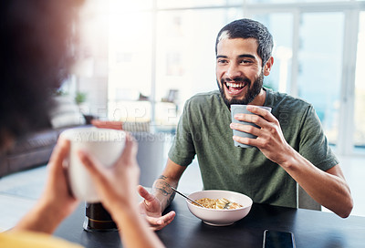 Buy stock photo Shot of a young couple having breakfast together at home