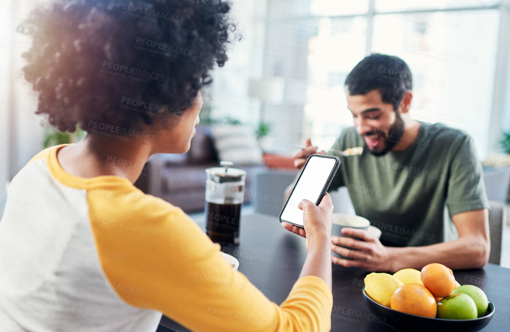 Buy stock photo Shot of a woman using her cellphone while having break at home with her boyfriend