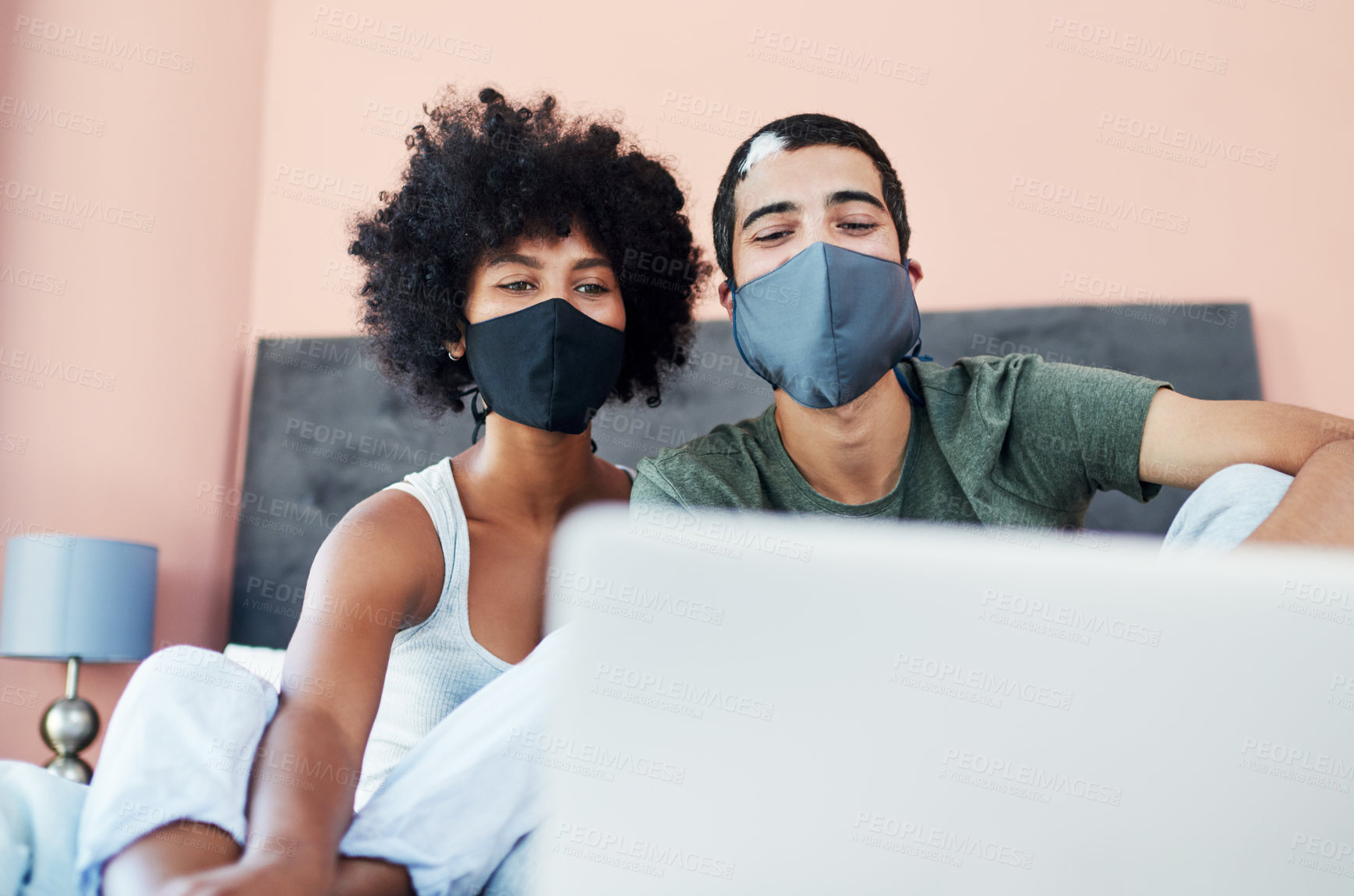 Buy stock photo Laptop, mask and streaming with couple in bedroom of home together for morning bonding or wellness. Covid, lockdown or quarantine with man and woman watching video on computer in bed at apartment