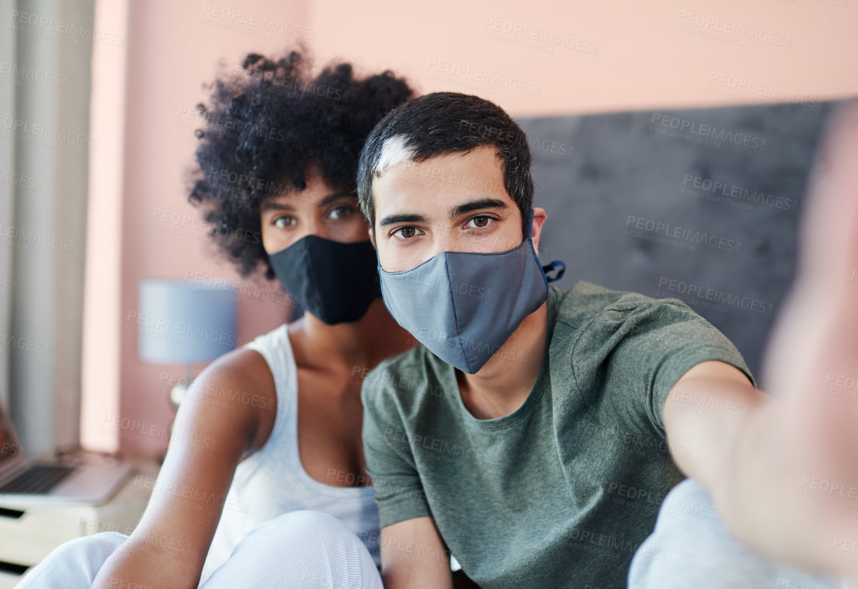 Buy stock photo Cropped shot of a young couple taking a selfie while wearing their masks
