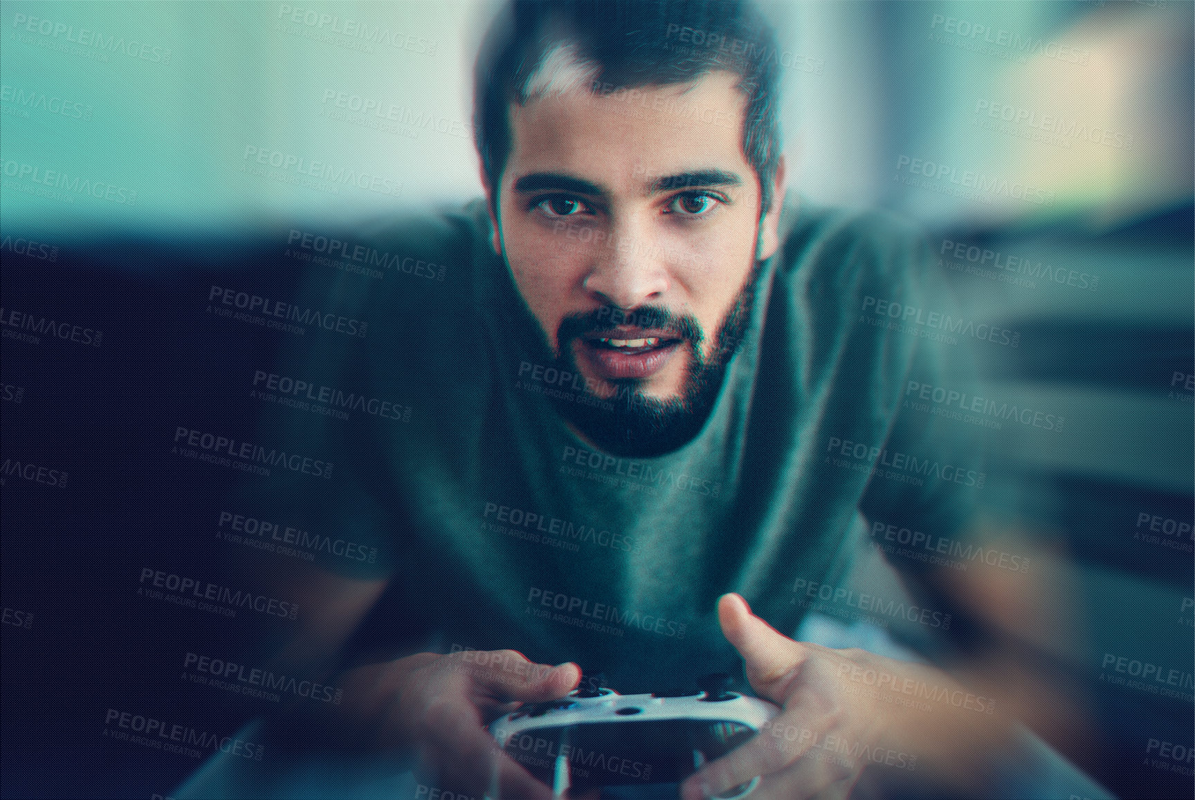 Buy stock photo Cropped shot of a young man sitting on the couch while playing video games