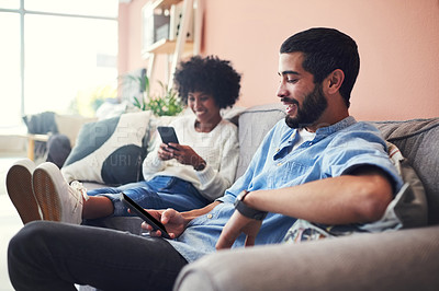 Buy stock photo Interracial couple, smartphone and laugh on sofa with home, living room and social media for comedy. Man, woman and cellphone for browsing, online video and comic joke or meme or communication