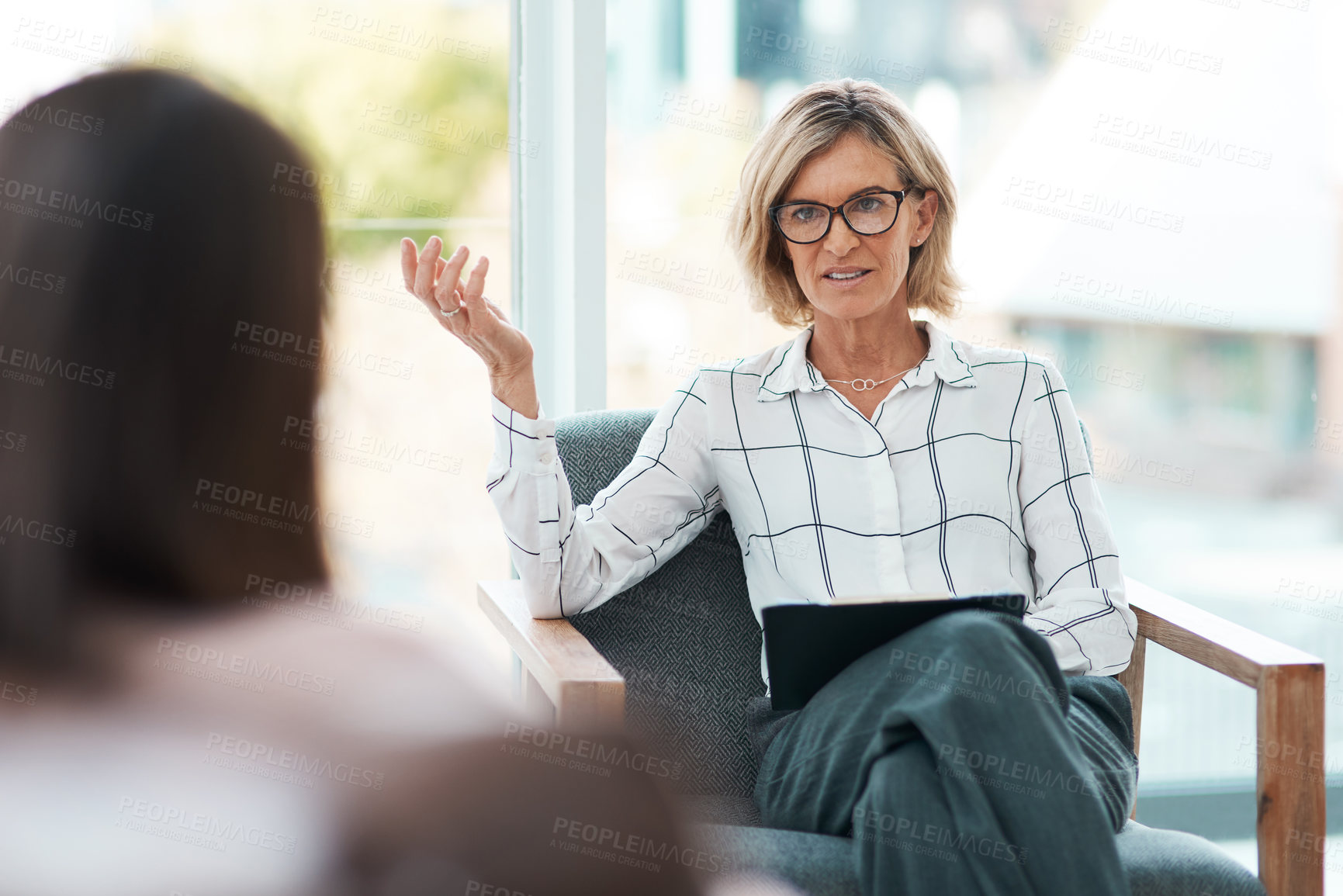 Buy stock photo Shot of a mature psychologist having a therapeutic session with her patient