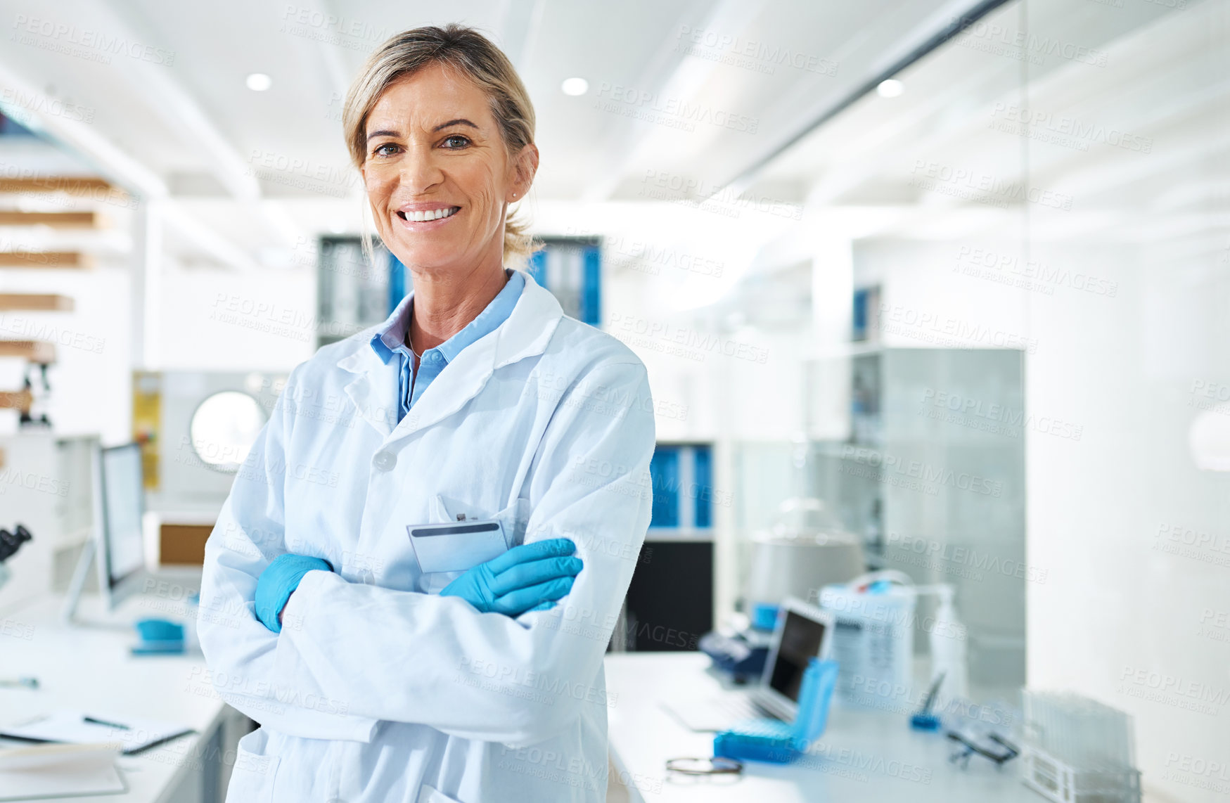 Buy stock photo Portrait of a mature scientist standing with her arms crossed in a lab