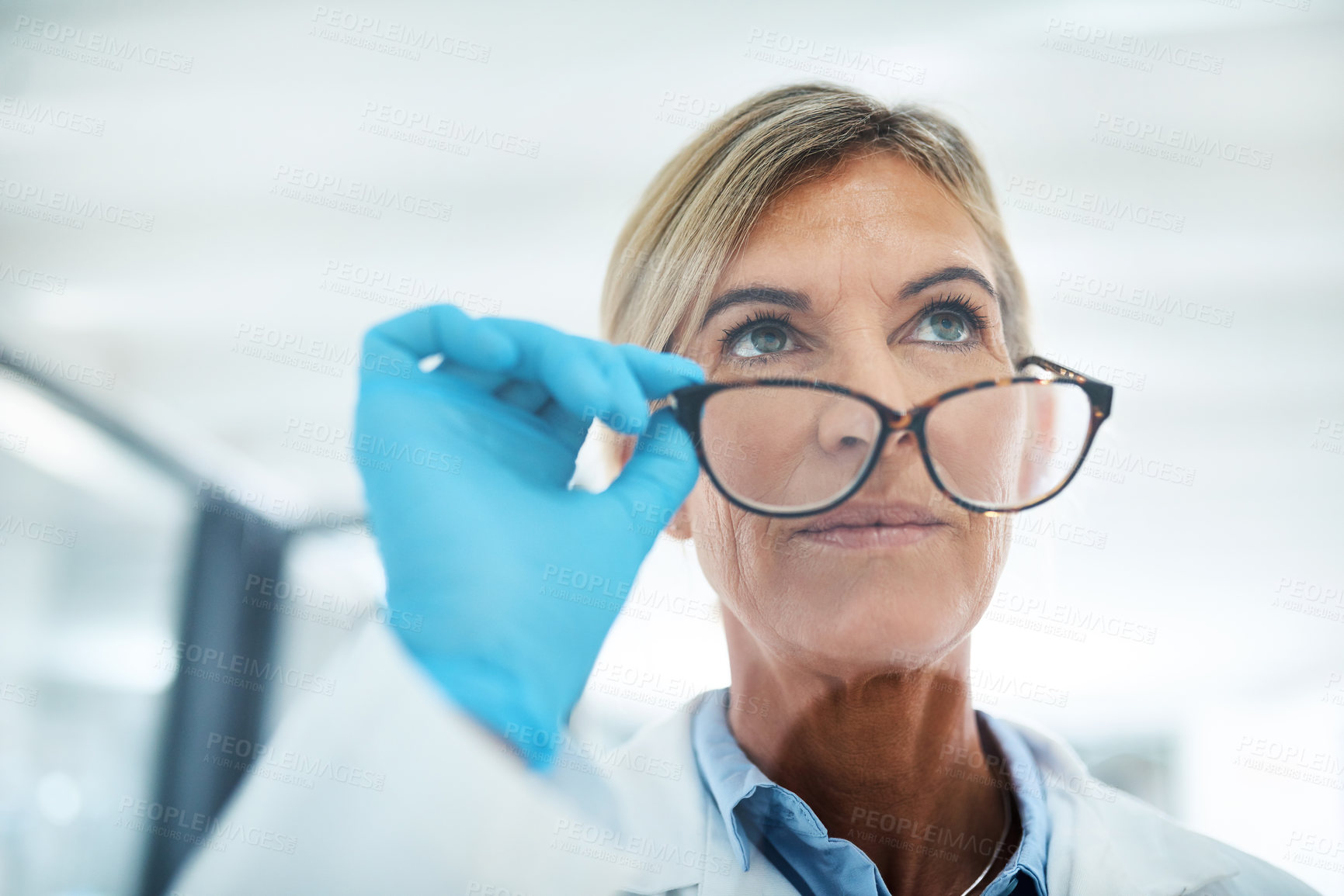 Buy stock photo Shot of a mature scientist looking thoughtful in a lab