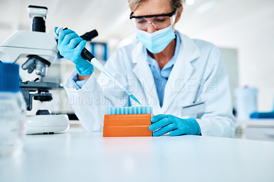 Buy stock photo Shot of a scientist using a dropper while working with samples in a lab