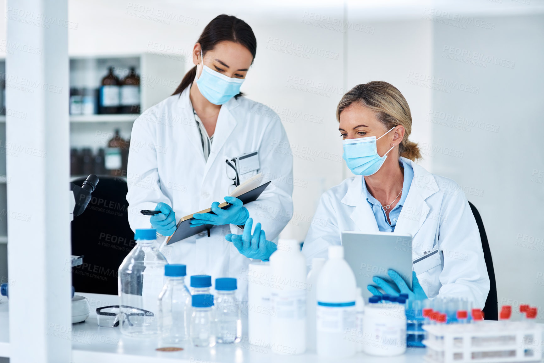 Buy stock photo Women, scientist and discussion in lab with notes, tablet and review for experiment results at pharma company. People, mentor and feedback with face mask, ppe and medical research for mpox vaccine