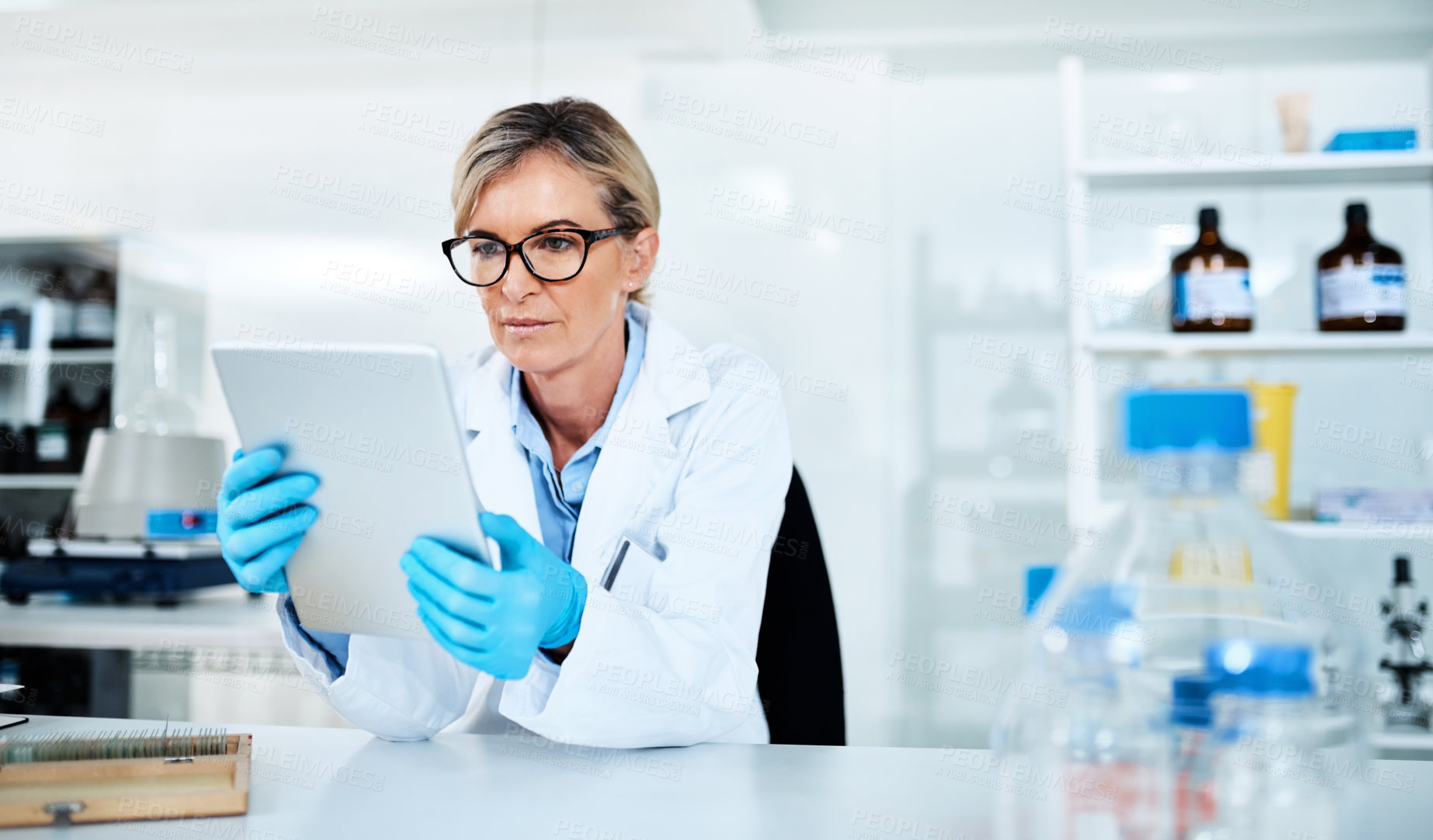 Buy stock photo Mature woman, scientist and tablet with gloves for medical research, discovery or results at laboratory. Female person, healthcare worker or biologist with technology for health development at lab