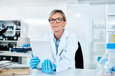 Buy stock photo Portrait of a mature scientist using a digital tablet in a lab