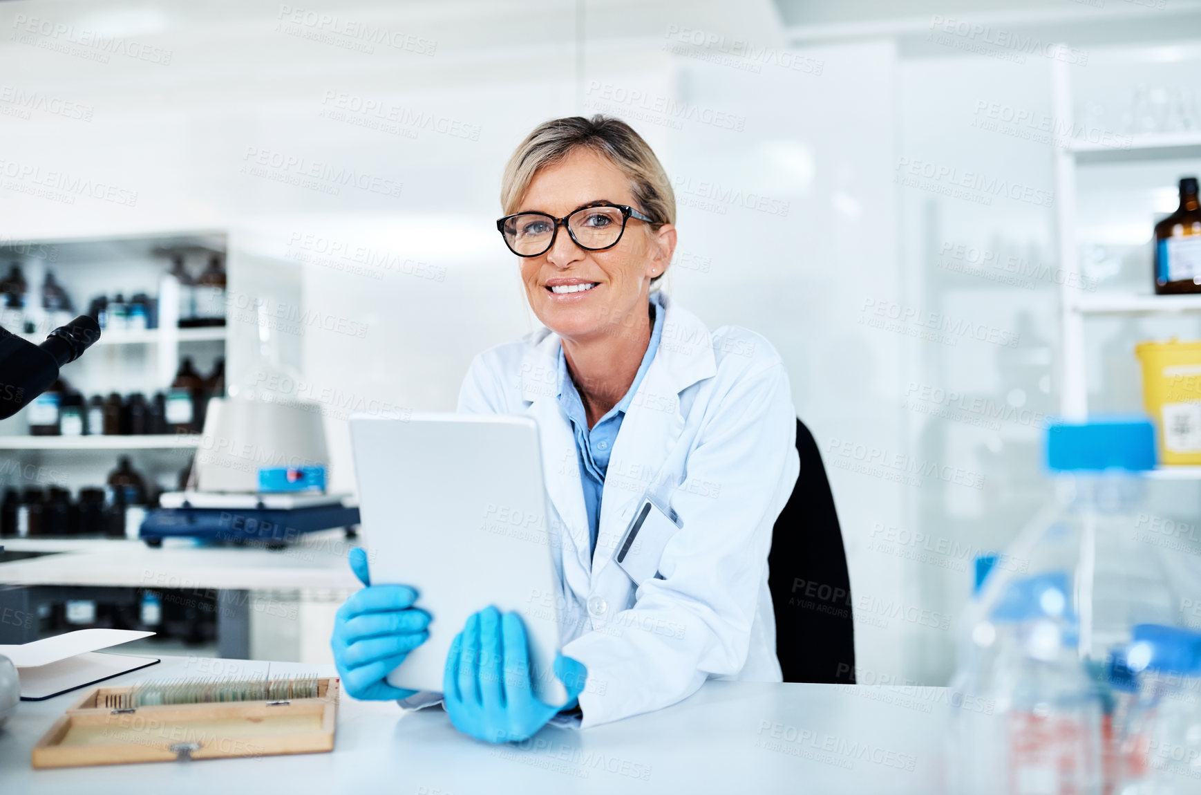 Buy stock photo Portrait of a mature scientist using a digital tablet in a lab