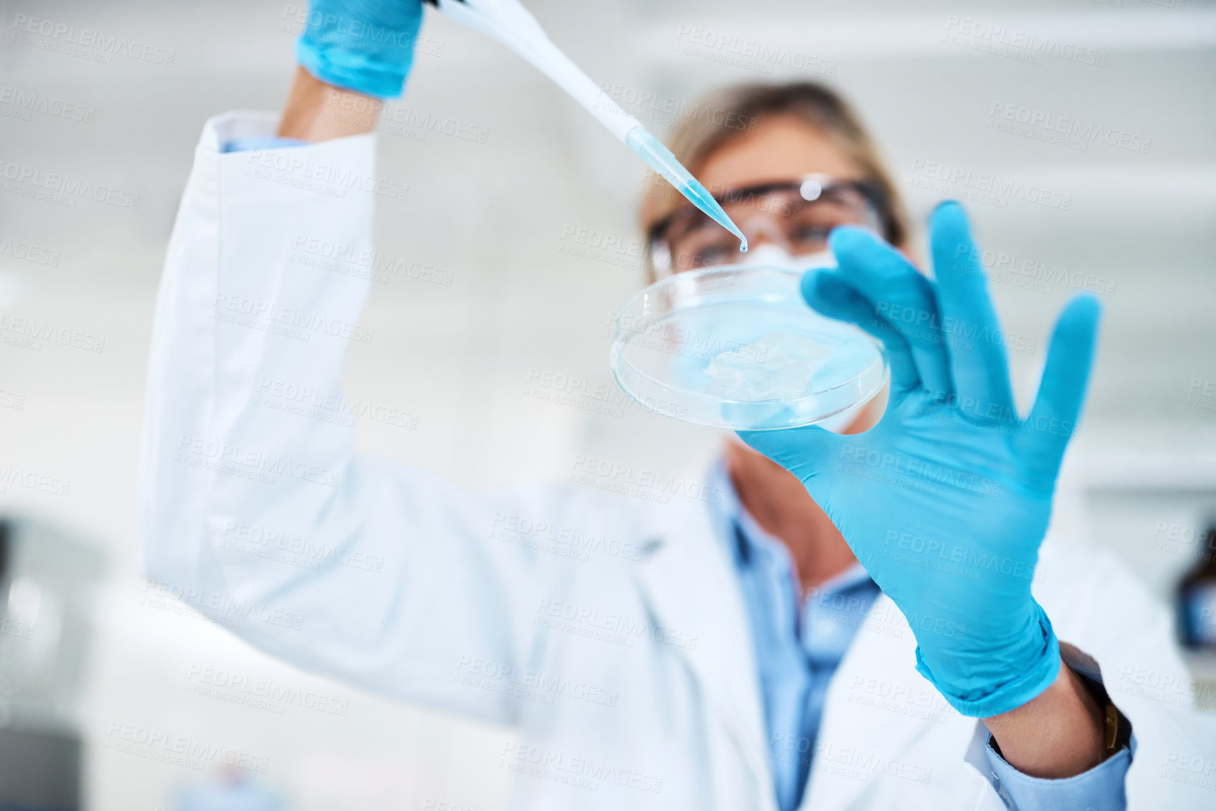 Buy stock photo Shot of a scientist using a dropper and petri dish in a lab