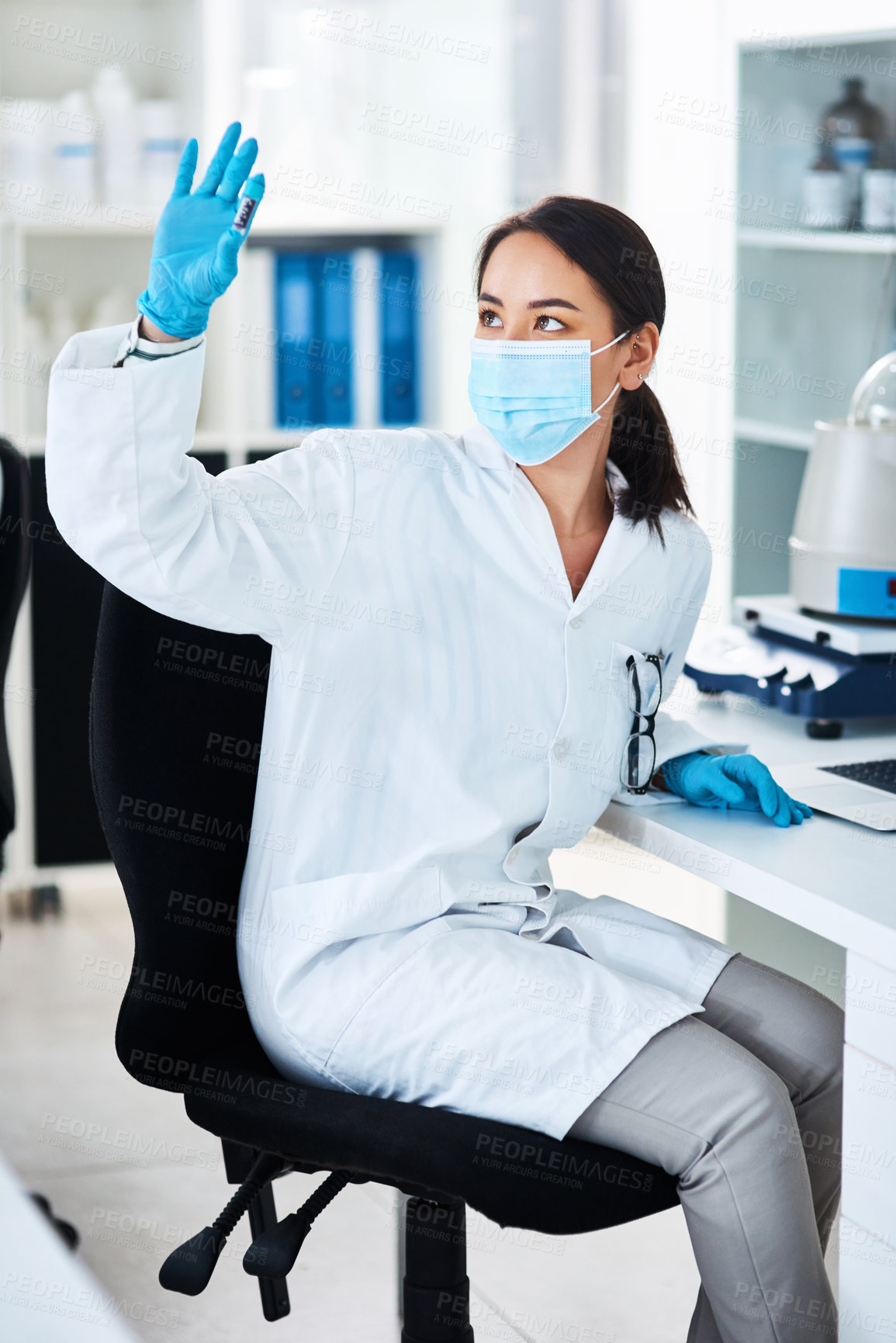 Buy stock photo Shot of a young scientist analysing samples in a lab