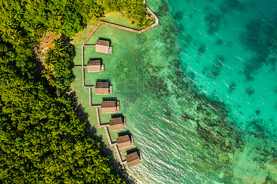 Buy stock photo High angle shot of the overwater bungalows along the coast of the Raja Ampat Islands in Indonesia