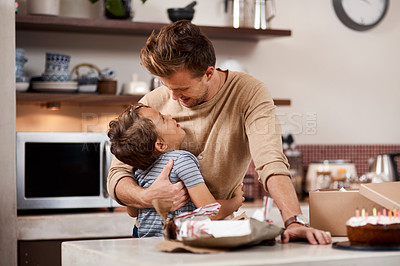 Buy stock photo Shot of a man embracing his son while celebrating his birthday at home