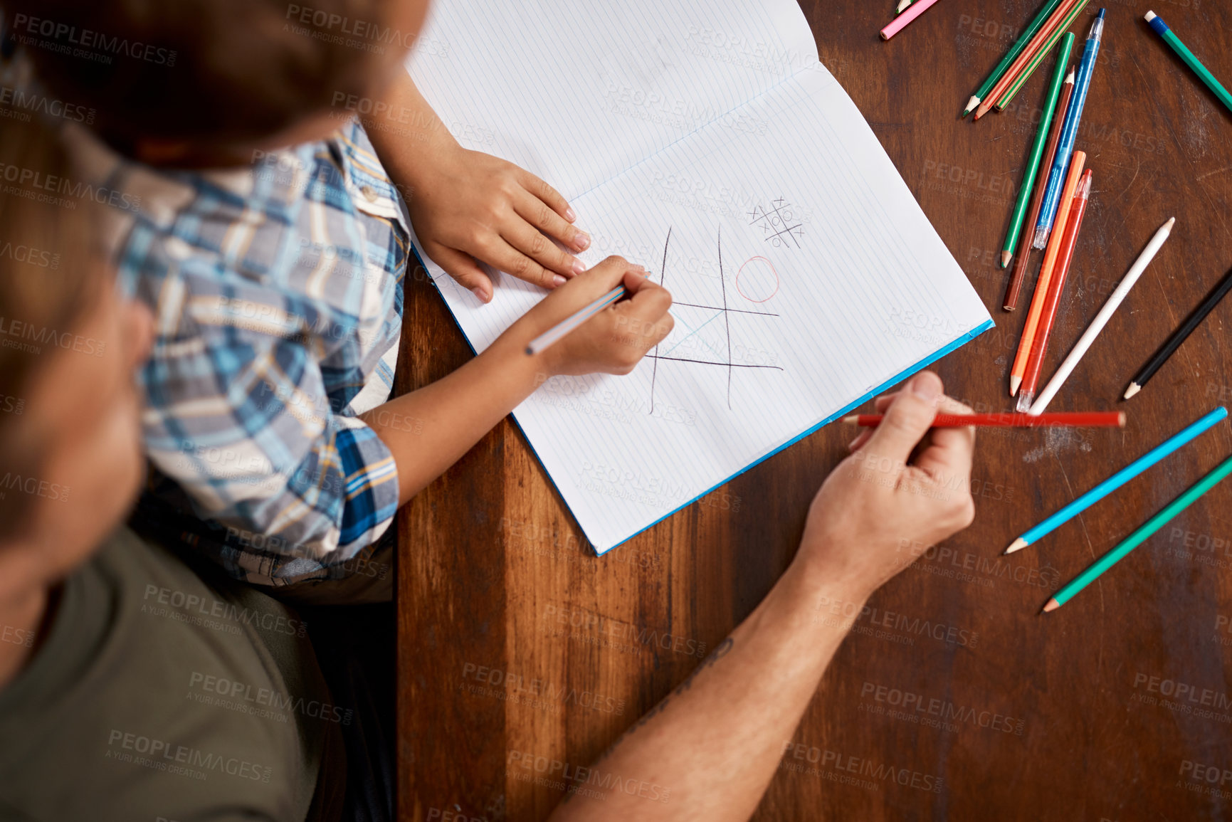 Buy stock photo Shot of a boy playing Tic-Tac-Toe with his dad at home