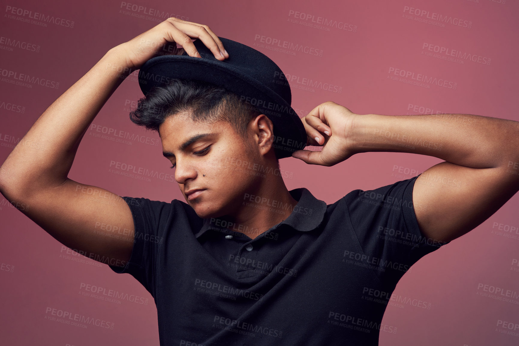 Buy stock photo Studio shot of a handsome young man wearing a hat