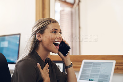 Buy stock photo Shot of a young businesswoman looking surprised while talking on a cellphone in an office