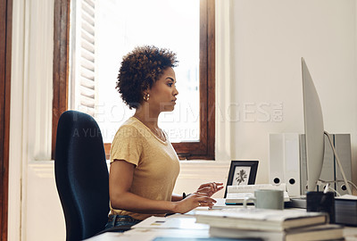Buy stock photo Serious business woman working on computer, reading emails and browsing internet while sitting at a desk in an office at work. Secretary or receptionist checking schedule and planning daily routine