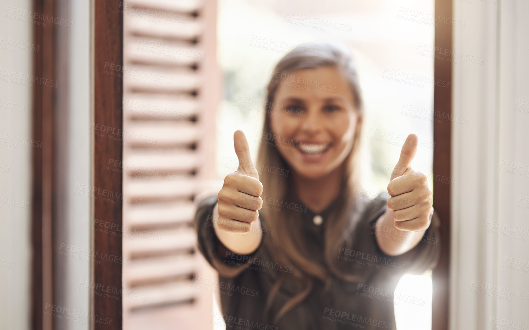 Buy stock photo Thumbs up from a happy woman smiling while showing a hand winning gesture in a modern office. Cheerful, positive  female looking excited after getting good news, feedback or a promotion at work