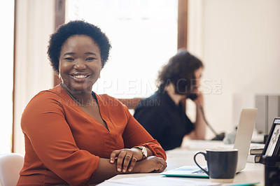 Buy stock photo Portrait of a confident young businesswoman working in an office with her colleague in the background