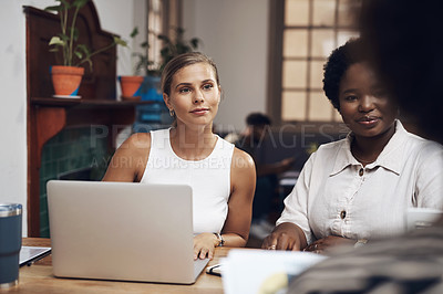 Buy stock photo Shot of a group of young businesswomen having a meeting in a modern office