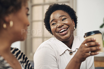 Buy stock photo Shot of two young businesswomen having coffee and a chat in a modern office