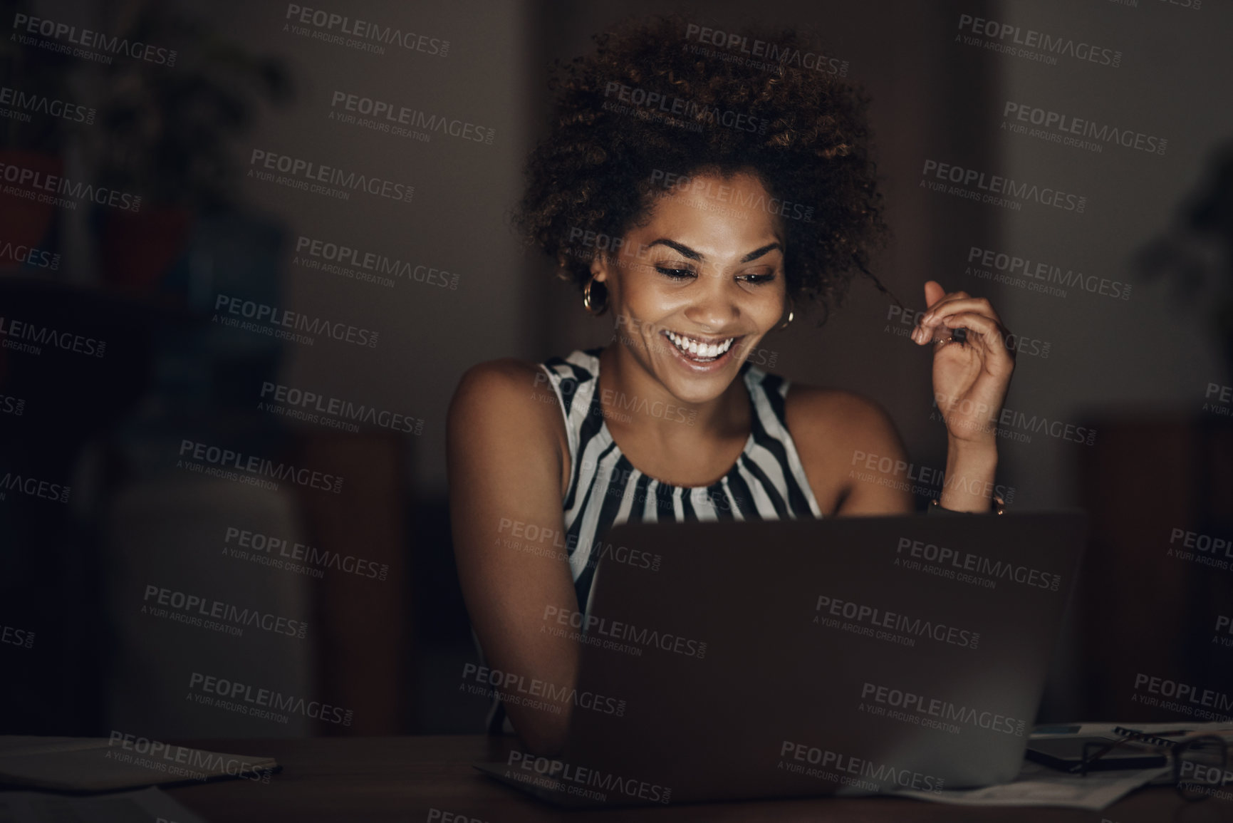 Buy stock photo Shot of a young businesswoman using a laptop during a late night at work