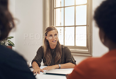 Buy stock photo Human resources manager meeting with colleagues, settling a dispute or argument in her office. Serious female leader talking, meeting and planning with her team and staff members at work