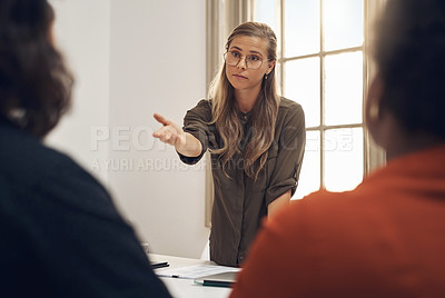 Buy stock photo Young, upset and professional businesswoman in a meeting with two workers having an argument. Group, team or people training and discussing at the office or leader blaming worker for poor performance