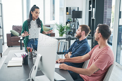 Buy stock photo Shot of a group of young businesspeople having a discussion in a modern office