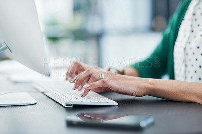 Buy stock photo Cropped shot of a businesswoman using a computer at her desk in a modern office