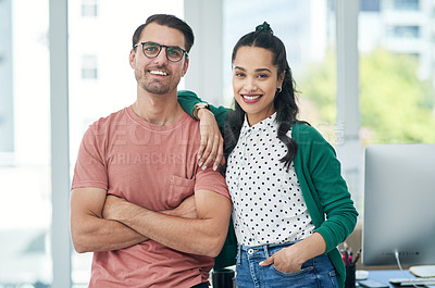 Buy stock photo Portrait of a confident young businessman and businesswoman working together in a modern office