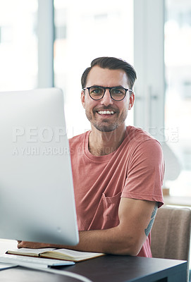 Buy stock photo Portrait of a young businessman using a computer in a modern office