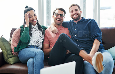 Buy stock photo Portrait of two young men and a woman relaxing together on a sofa